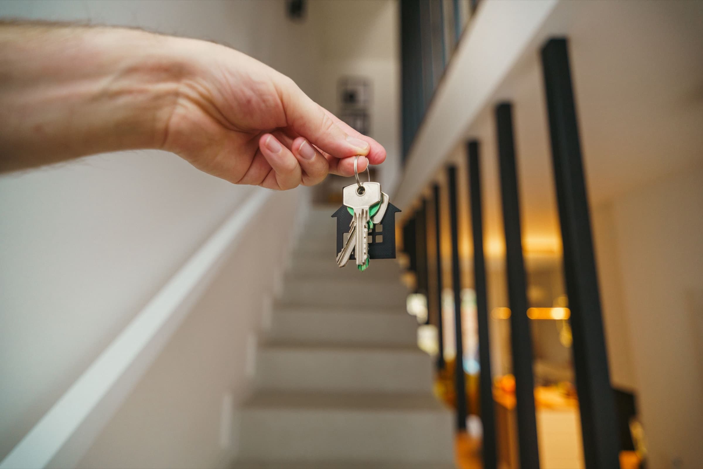 A set of house keys held inside a recently completed home