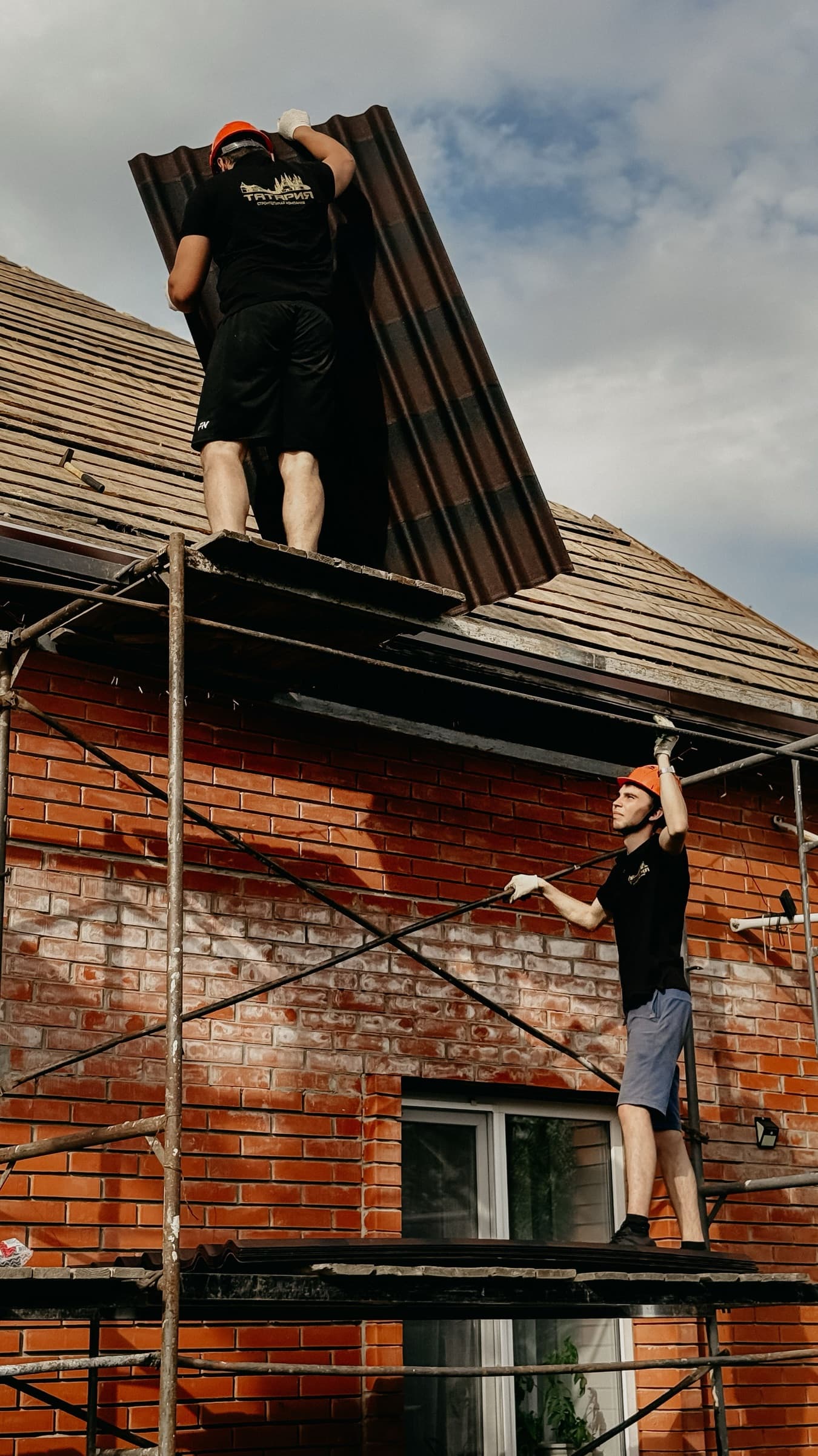 Roofers completing structural improvement work on a home