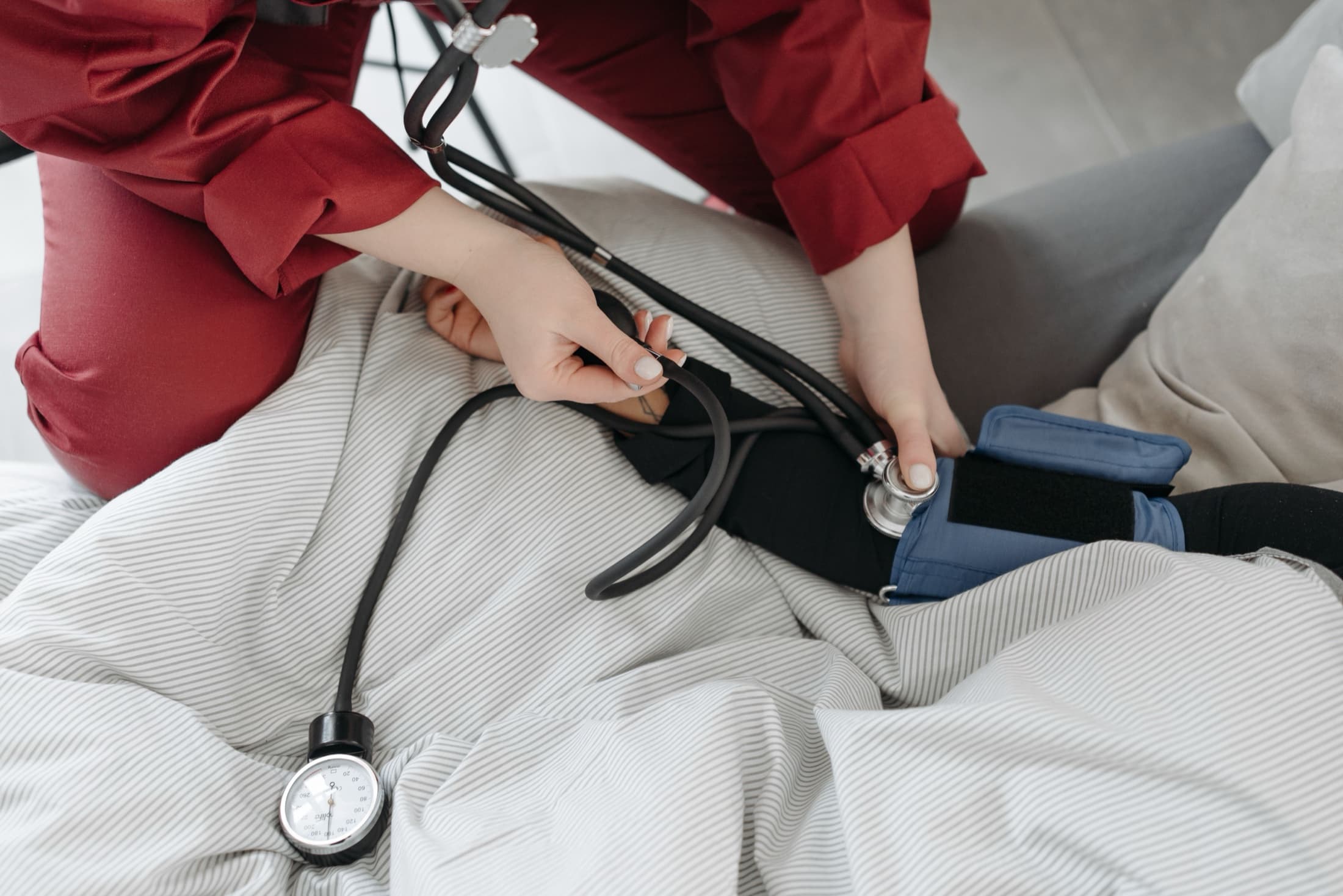 A clinician taking a patient's blood pressure
